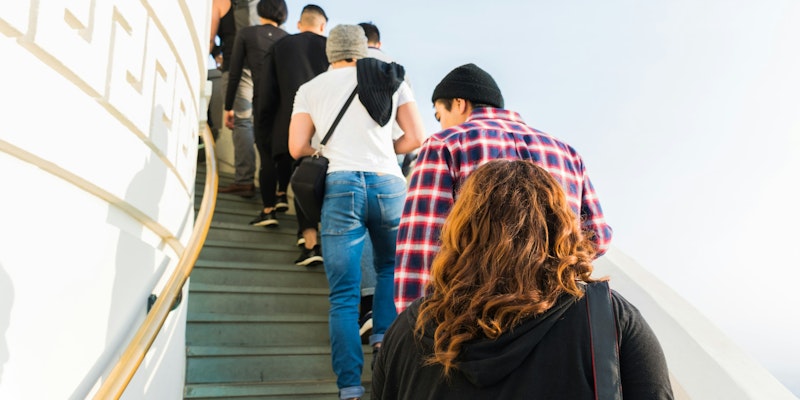 group of people on stairs under clear white sky