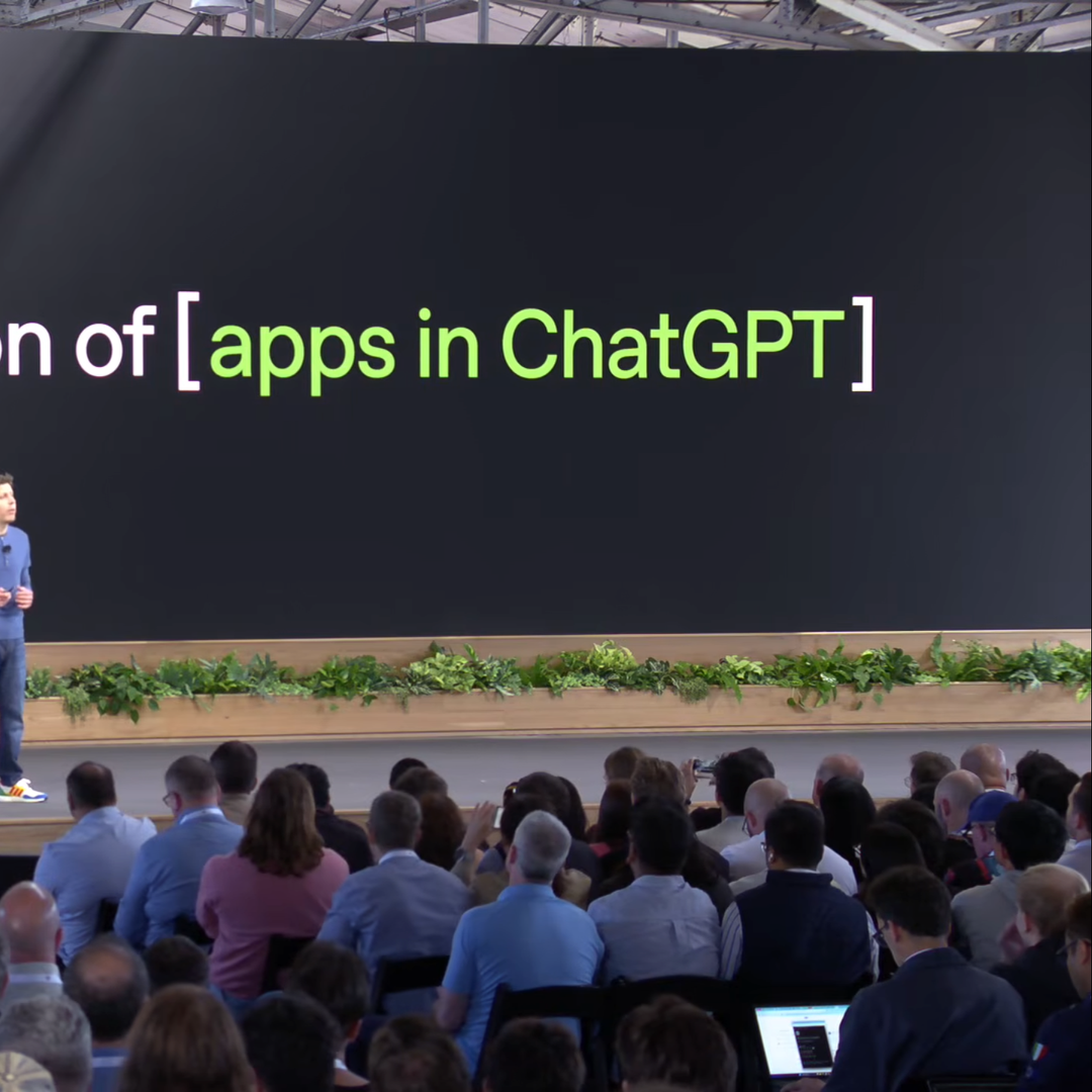 Square hero for the The Apps In ChatGPT Playbook: Apps SDK, MCP & ACP Strategy for Brands (2026) article: an OpenAI DevDay stage with the headline 'a new generation of [apps in ChatGPT]'. By Fantasy.