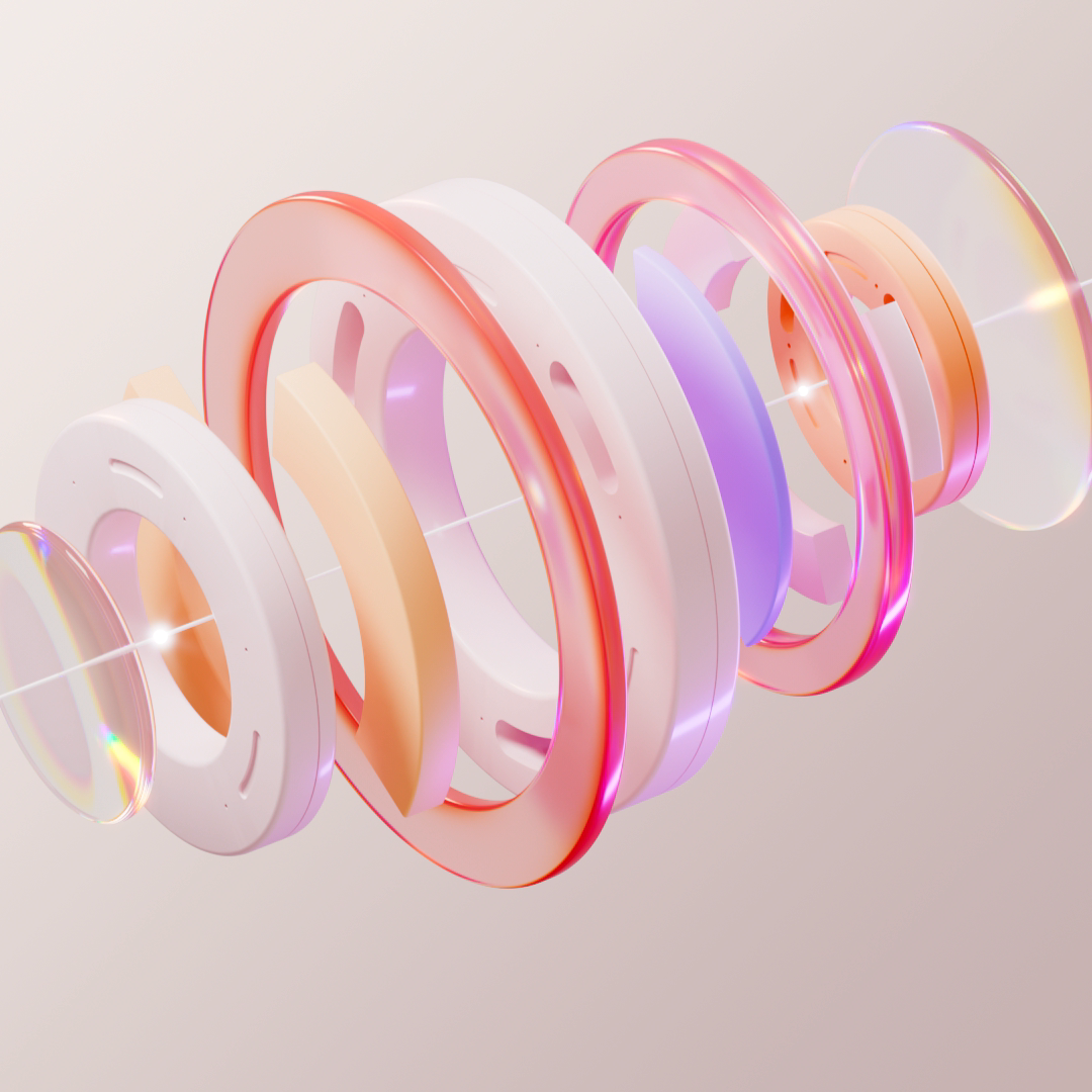 The prototype is the product article square hero Square hero for The prototype is the product article: a stack of white, orange and pink glass discs and rings with a line of light running through their center. By Fantasy.