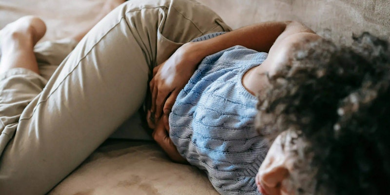 Imagem de mulher com dor no estomago, indicando necessidade de uso de Esogastro.