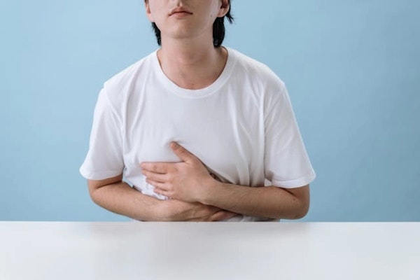 Imagem de uma pessoa com dor no estomago, indicando necessidade de uso de pantoprazol.