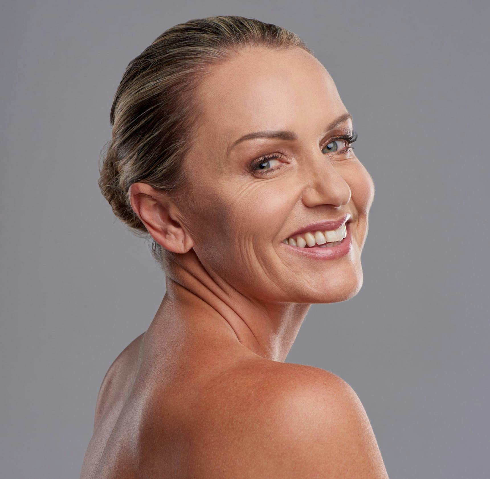 woman looking over her shoulder and smiling