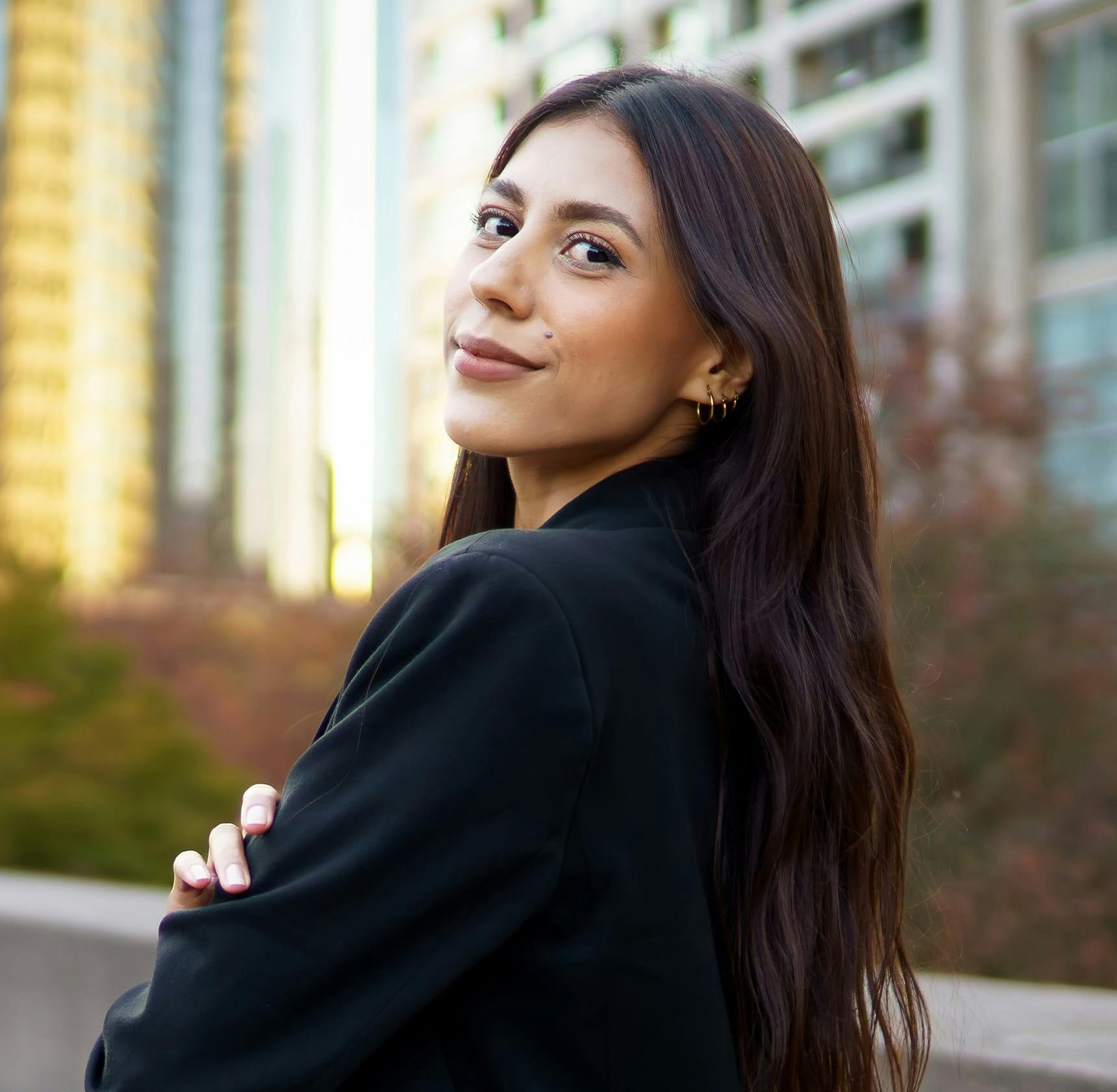 woman looking over her shoulder outdoors