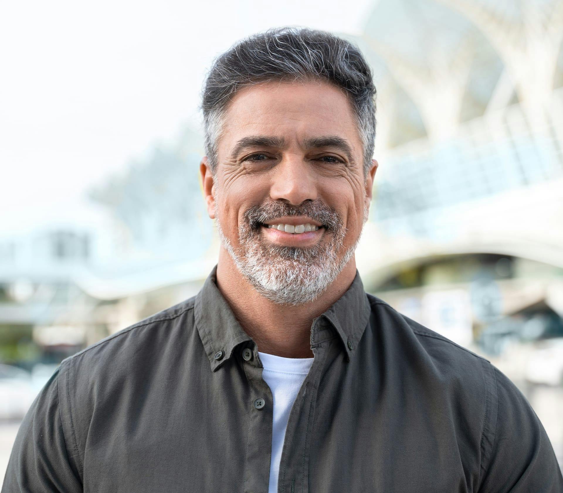 man with his beard slightly grey while wearing a black top