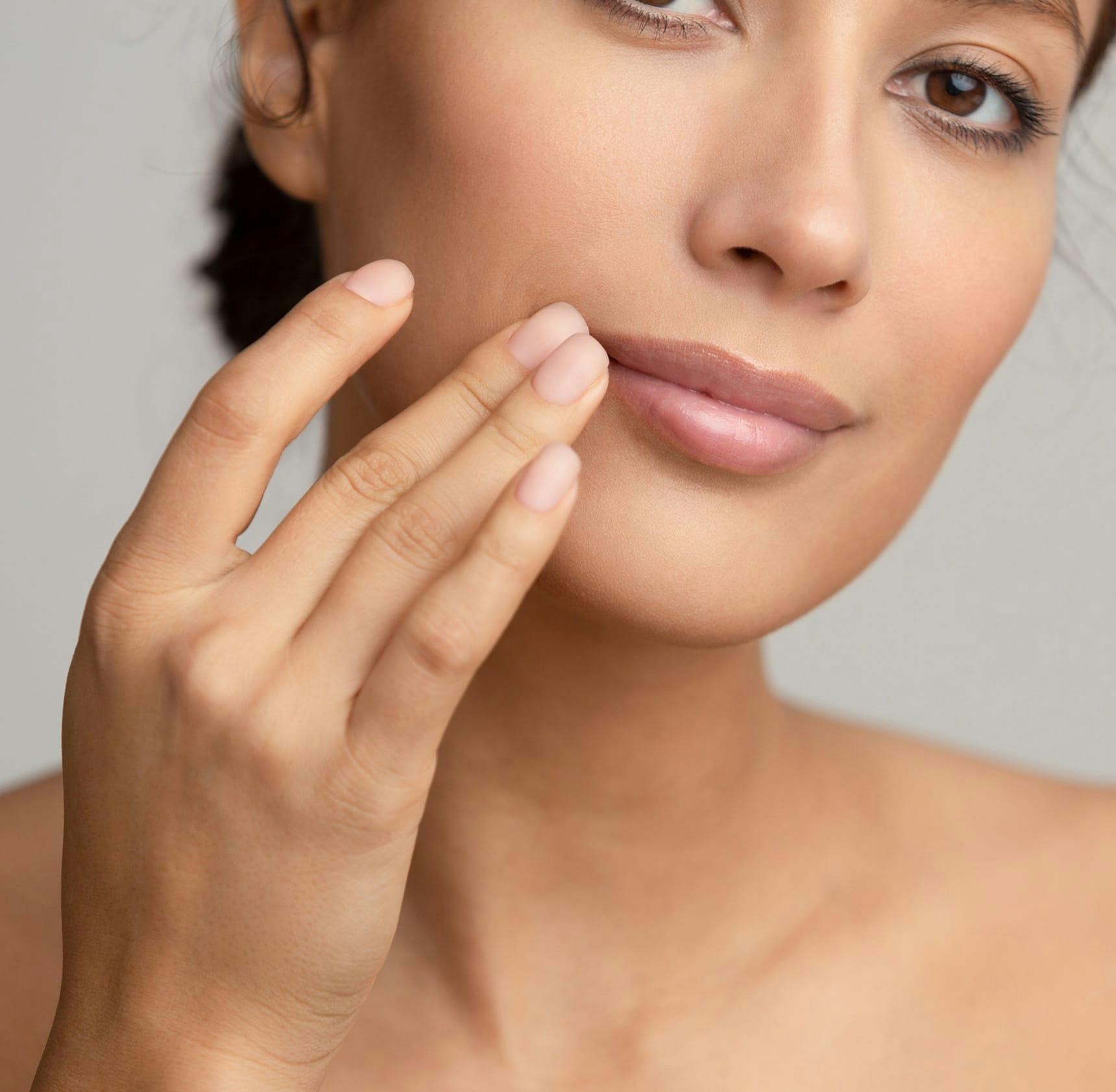 close up on woman touching the corner of her lip
