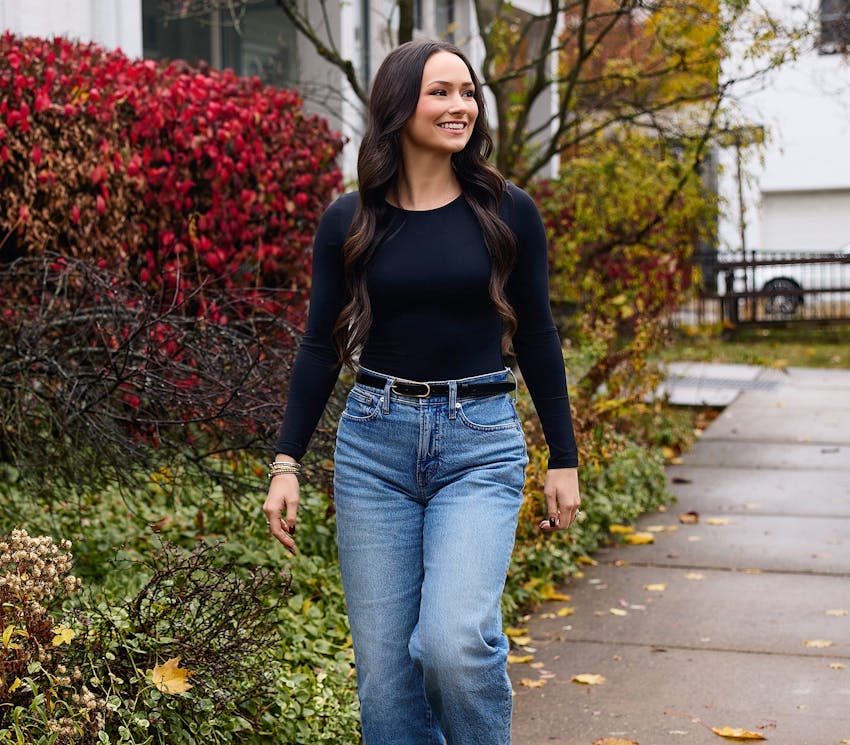 female patient walking outside and smiling