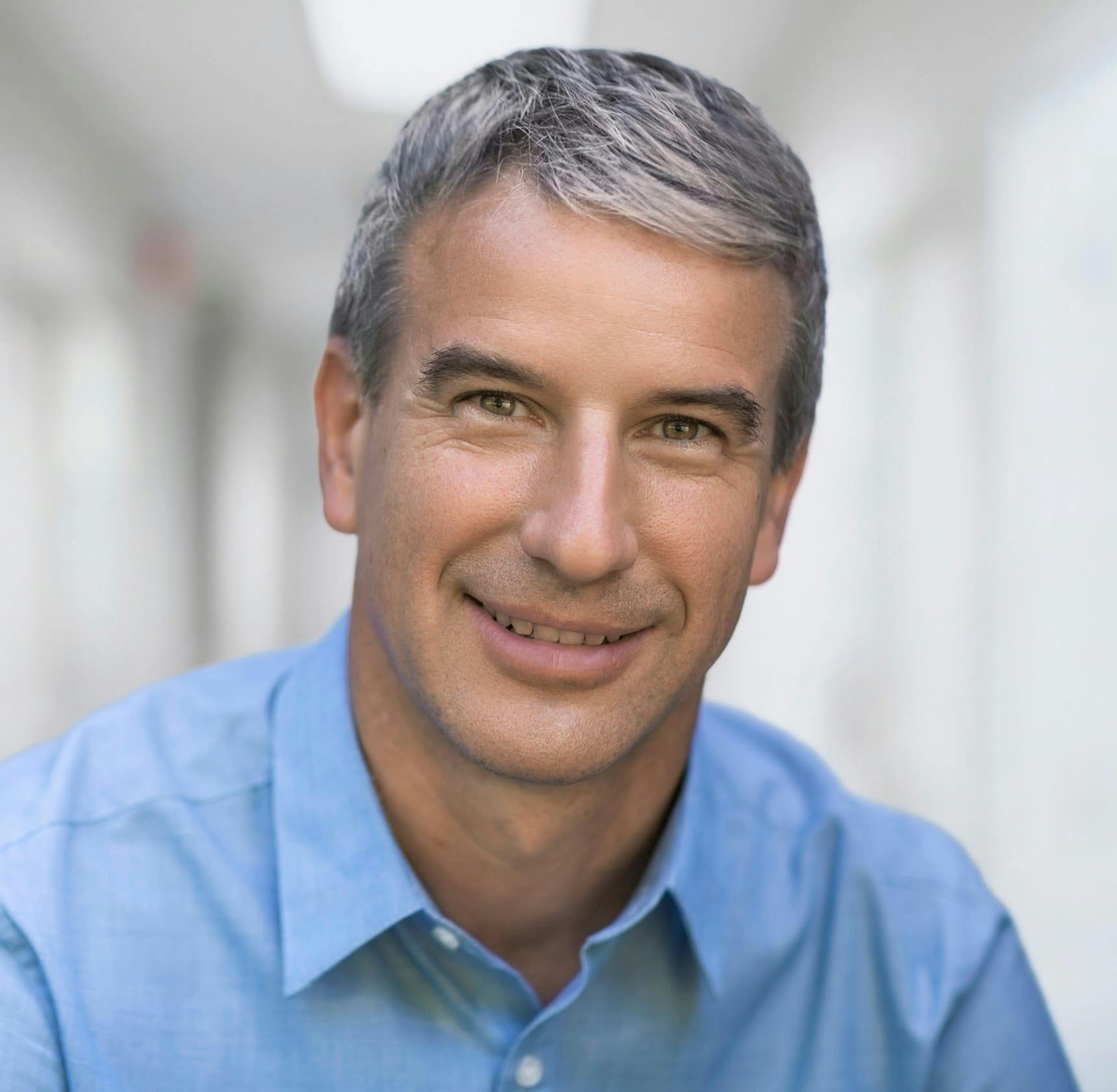 man in blue shirt smiling