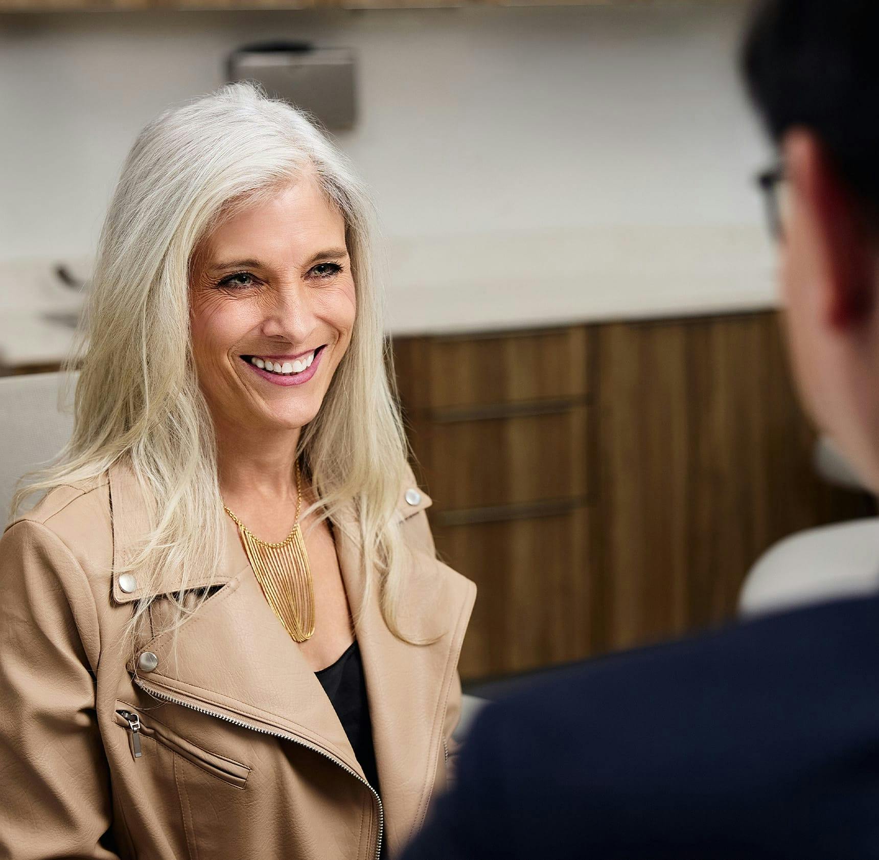 female client smiling at Dr. Leong