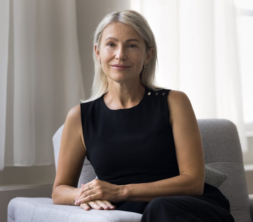 woman smiling and sitting on the couch