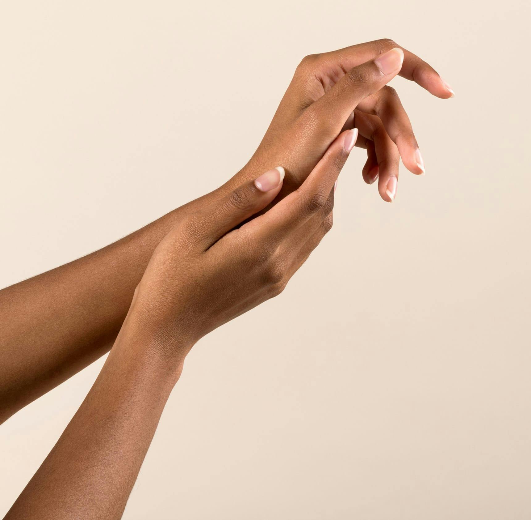 close up on woman's hand touching her palm