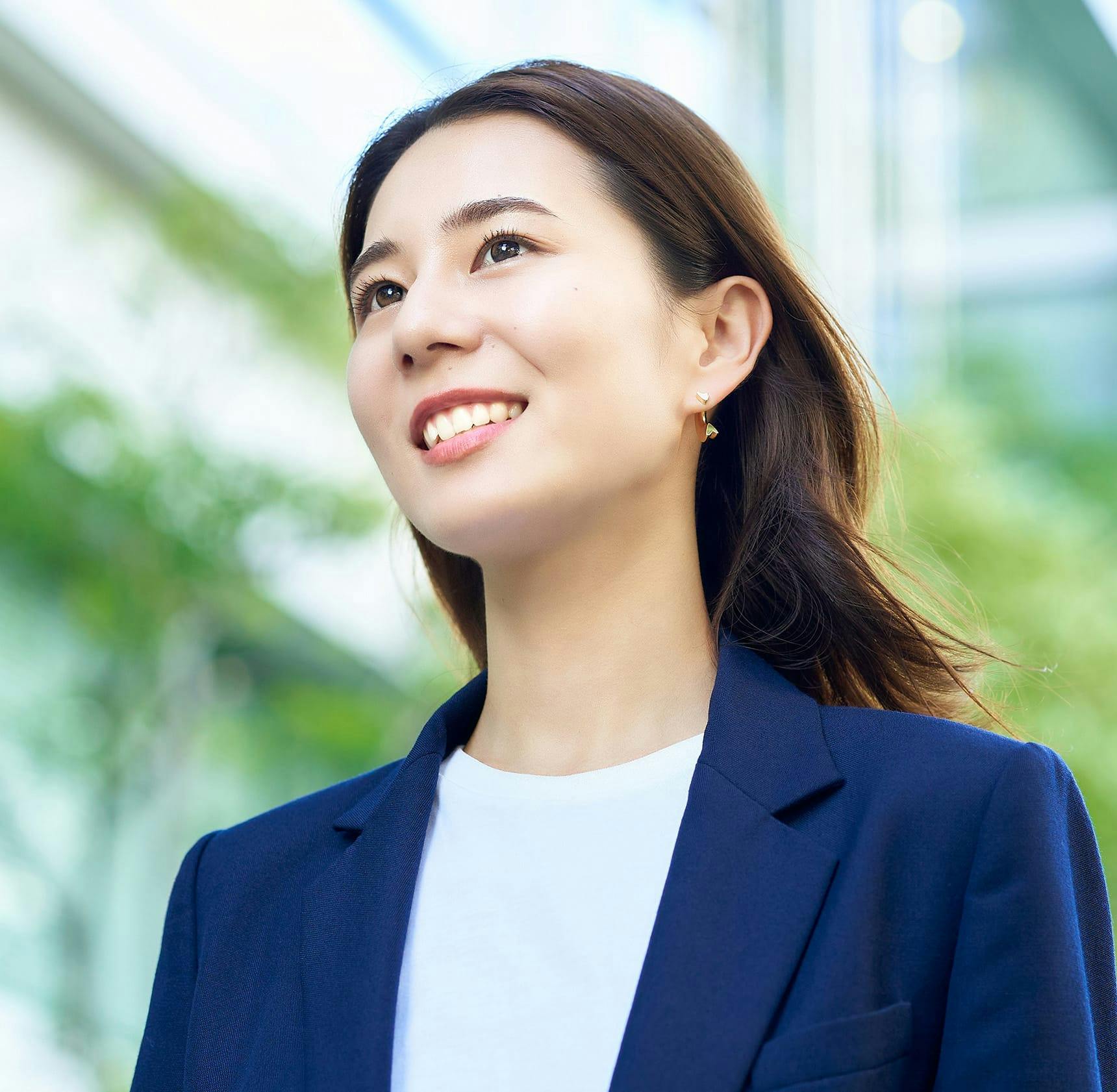 asian woman in blue suit jacket smiling