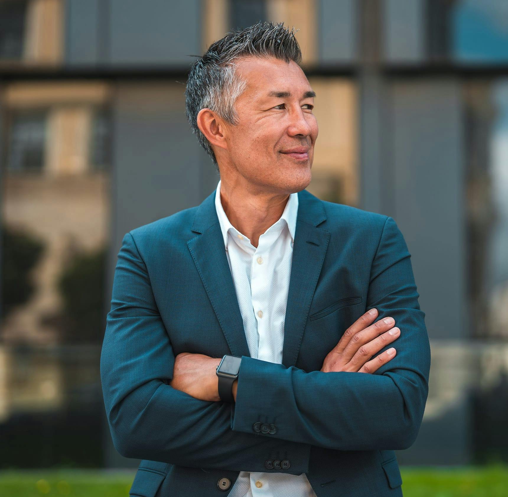 man in suit crossing his arms