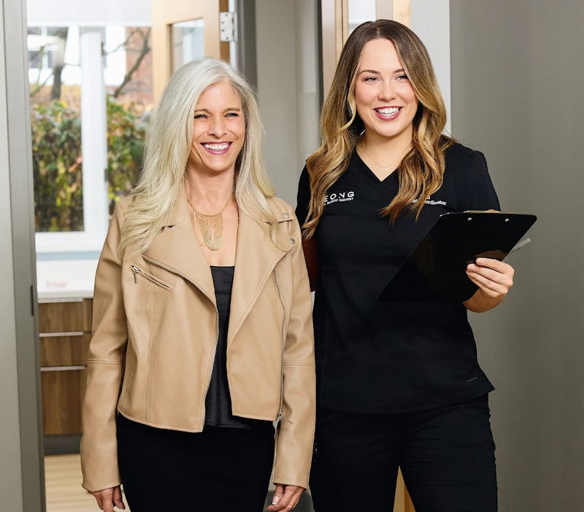 woman walking with staff member down the hallway