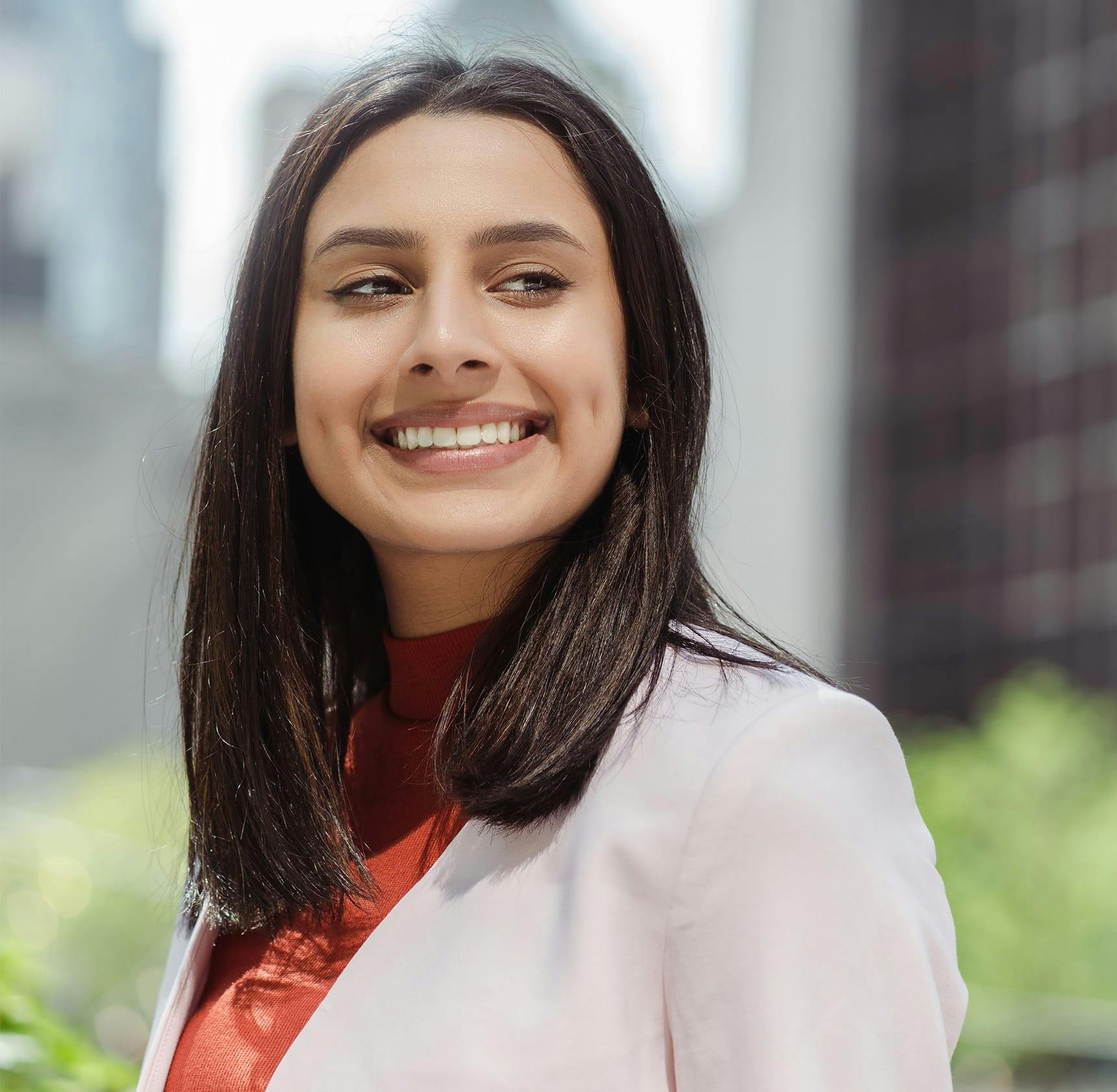 woman smiling outside in the city