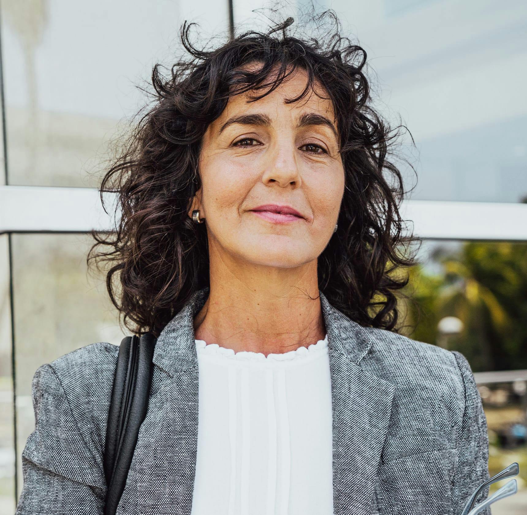 woman outside in grey suit jacket