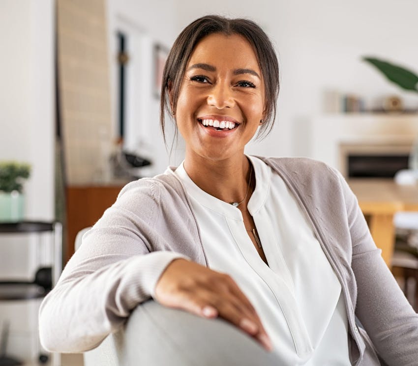 woman sitting on couch and smiling