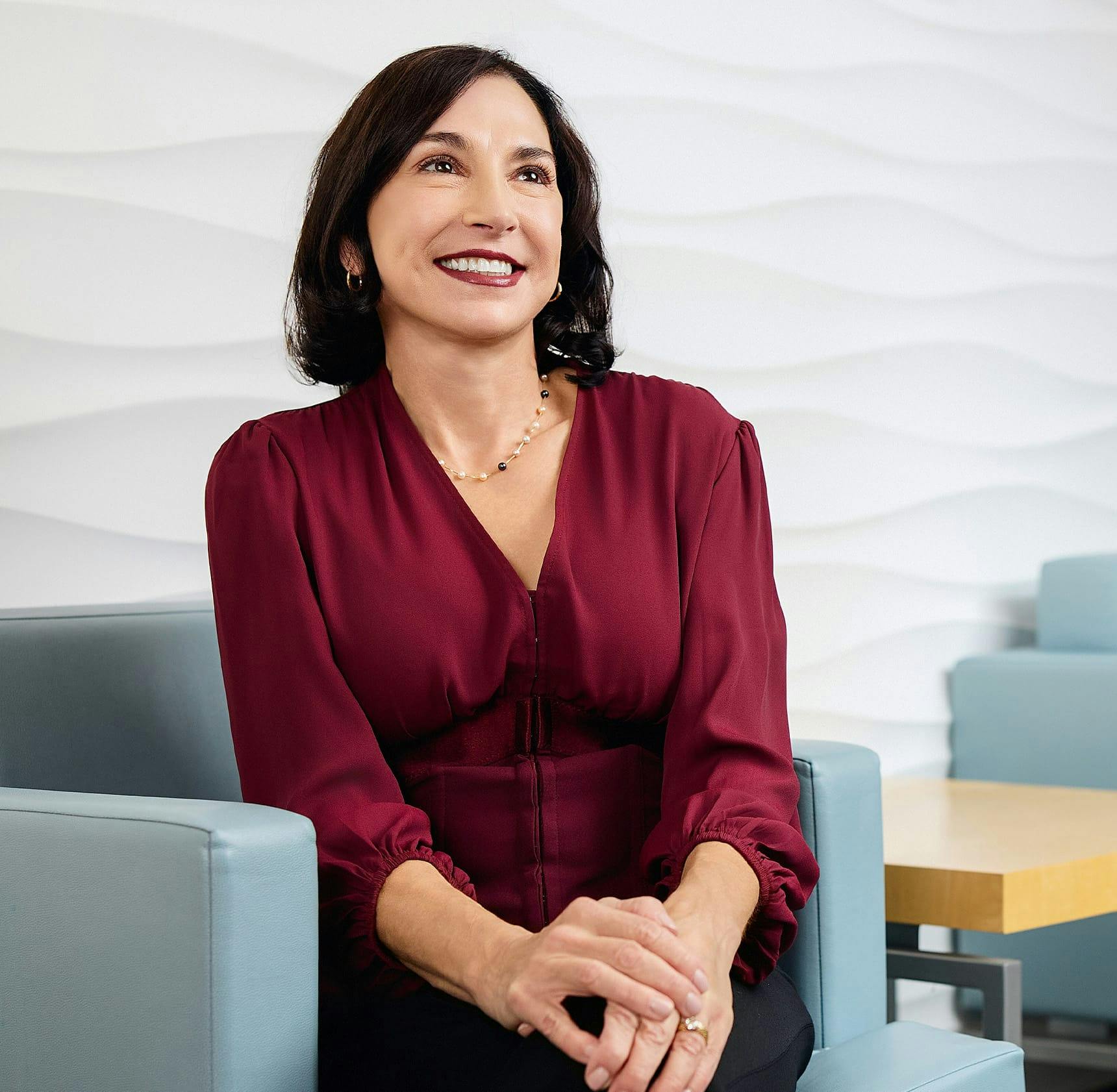 woman sitting down and smiling