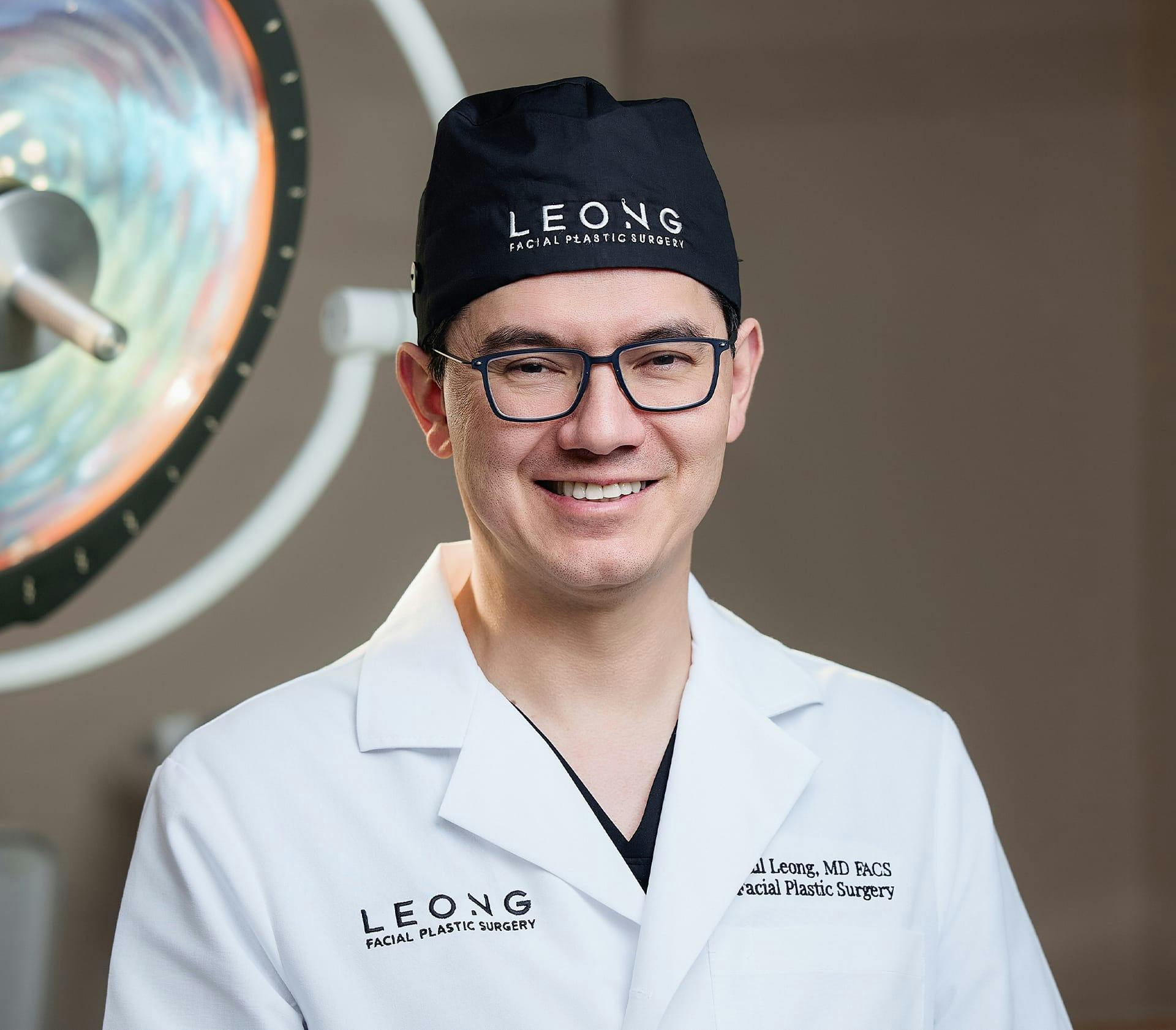 Dr. Leong smiling in his professional attire