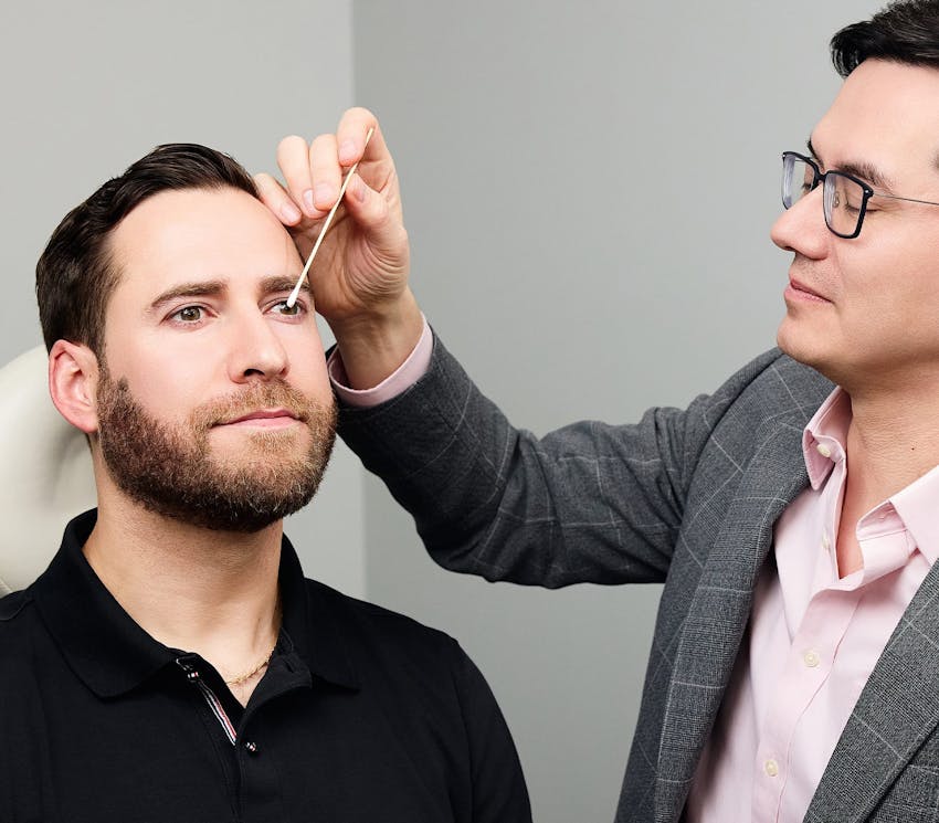 doctor looking at client's bridge on his nose