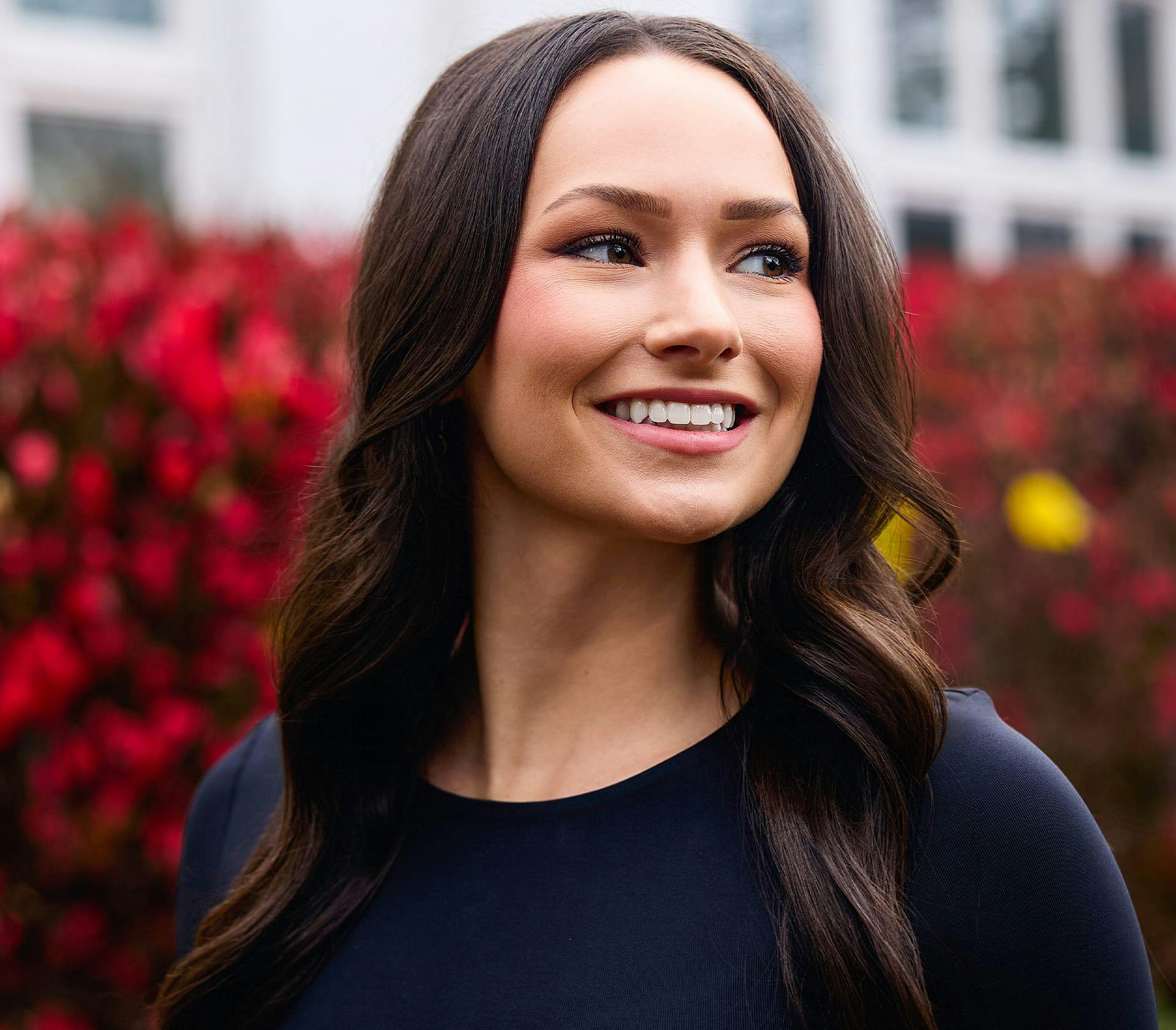female client outside while smiling
