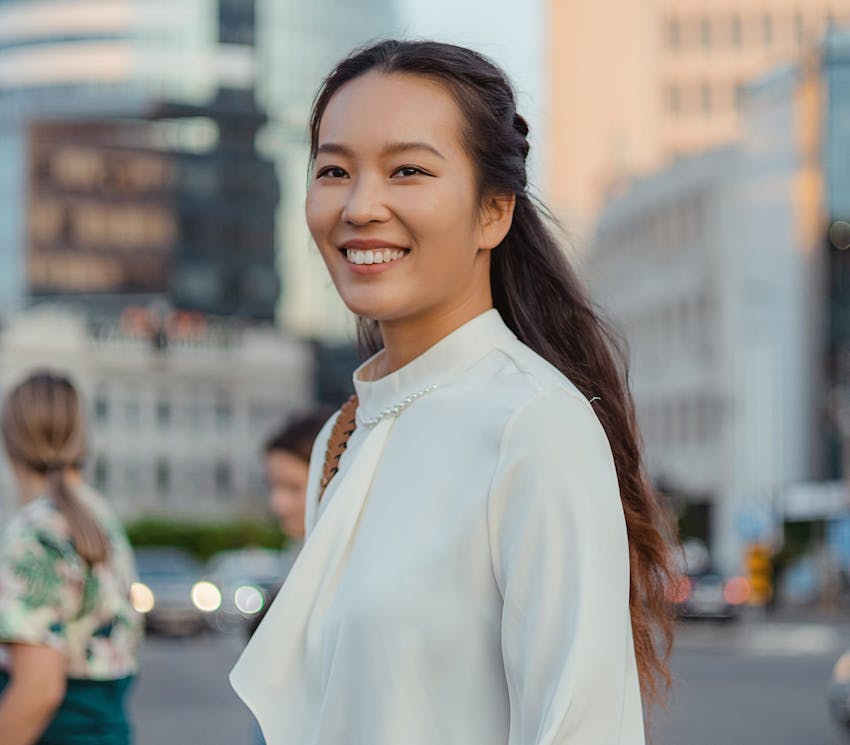 woman smiling while crossing the street