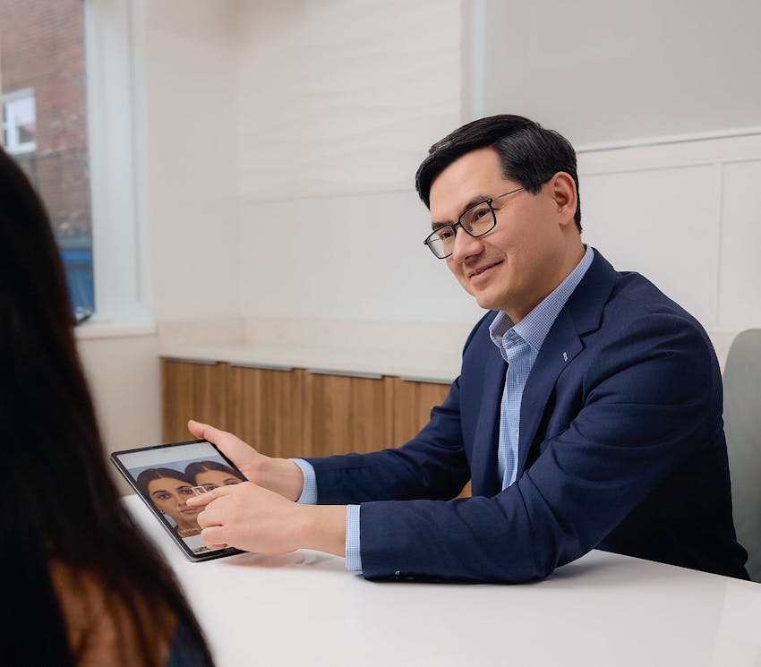 Dr. Leong showing patient before and afters