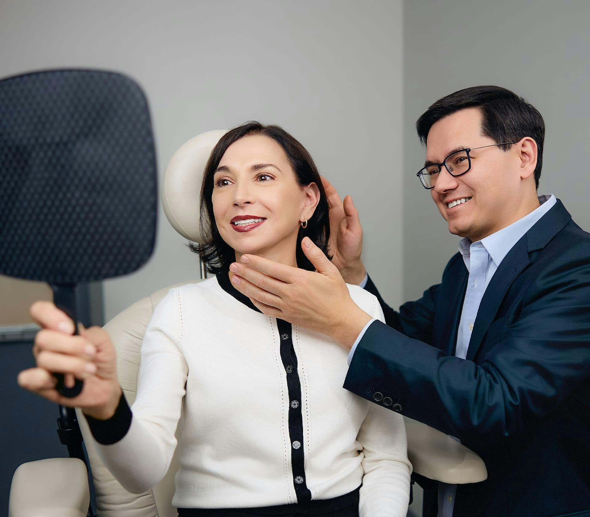 female client getting her ears checked by doctor