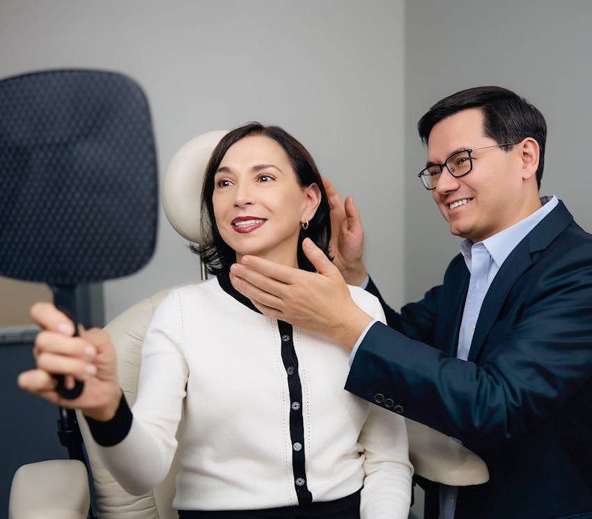 female client getting her ears checked by doctor