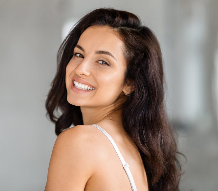 woman smiling while looking over her shoulder