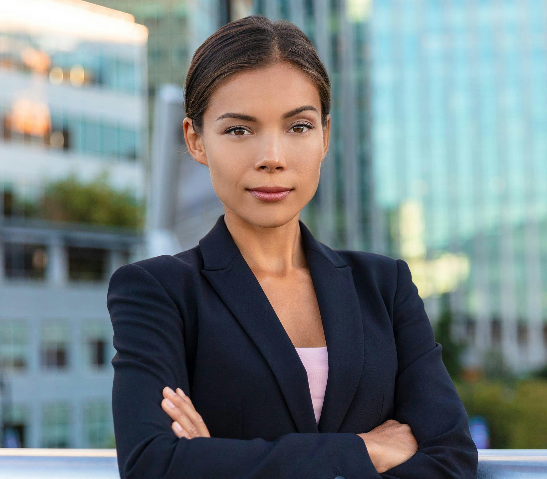 woman in suit jacket with arms crossed