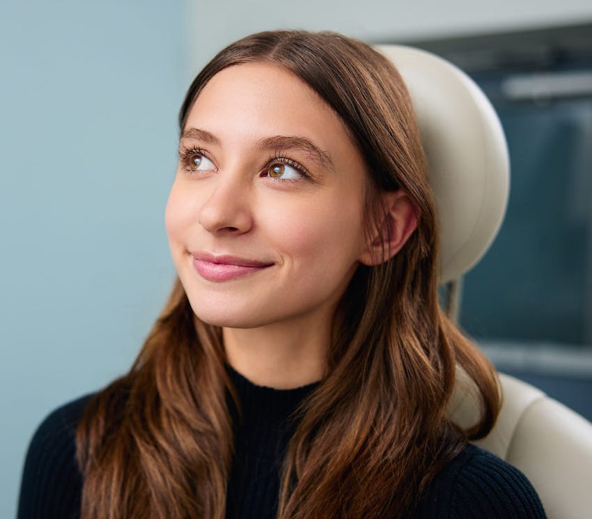 female patient sitting in examination chair