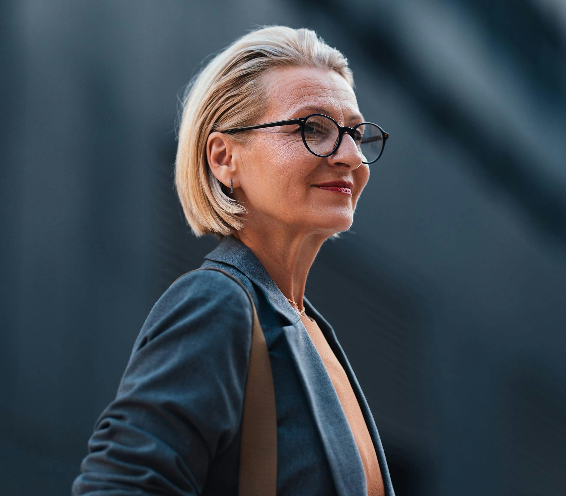 woman with blonde short hair wearing glasses