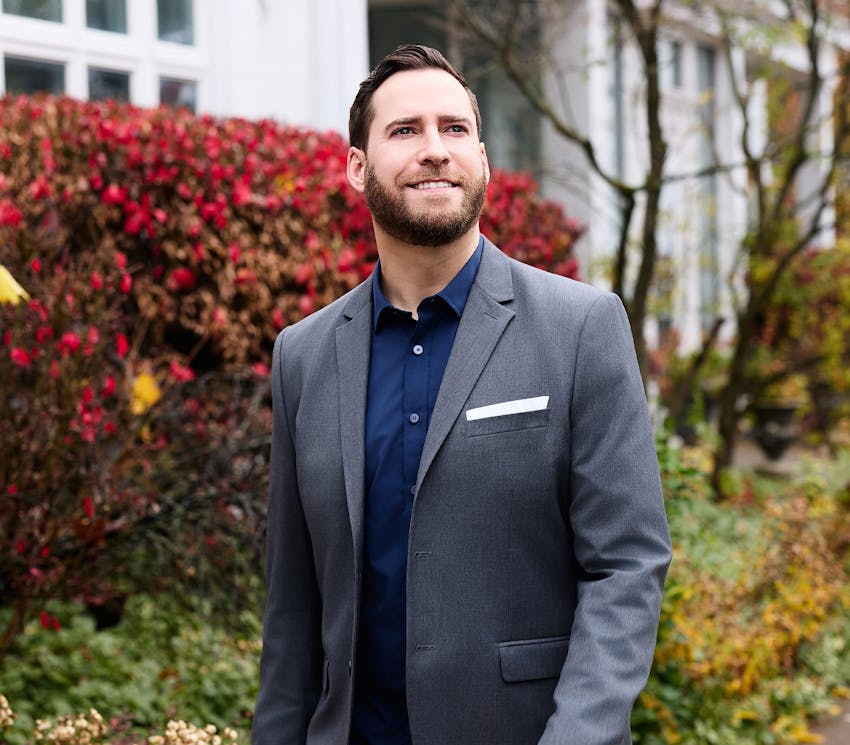 male client walking past some greenery
