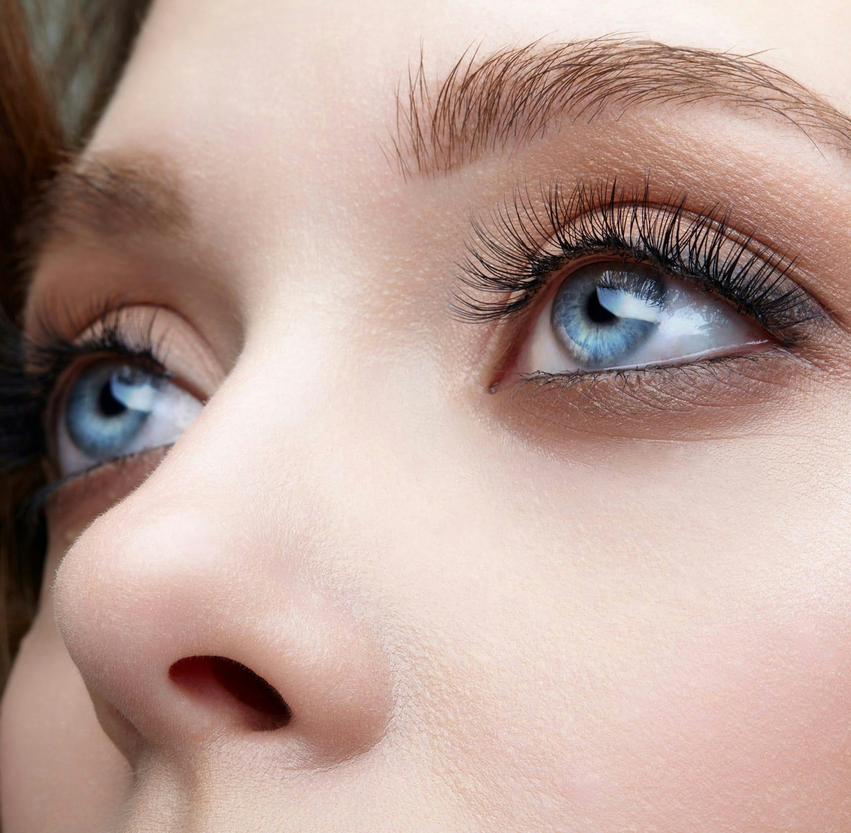 zoomed in on woman's bright blue eyes