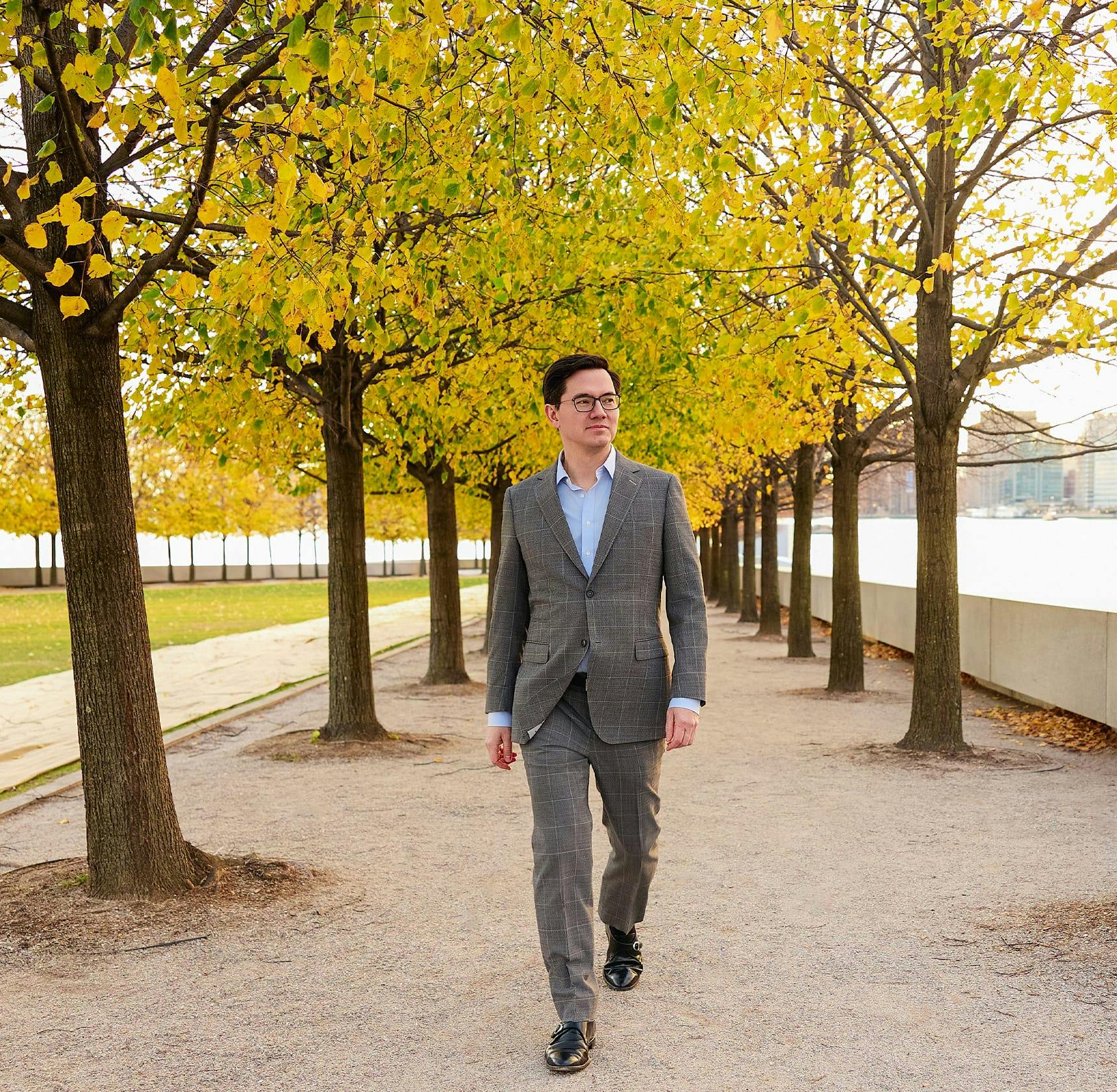 Dr. Leong walking outside in suit