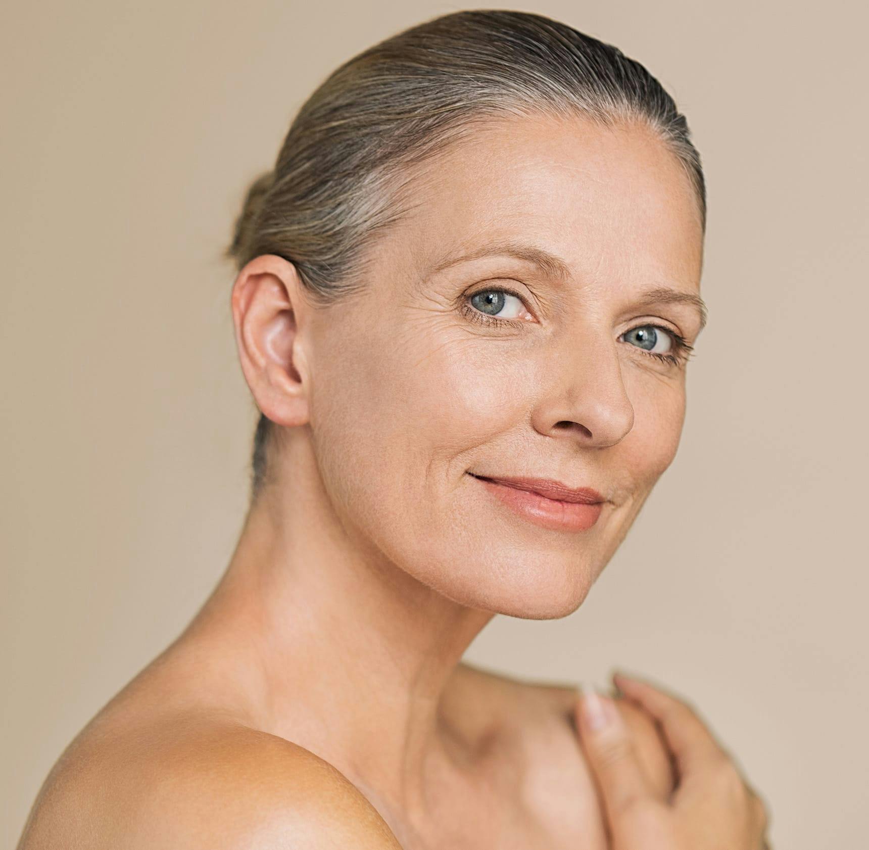 woman with her hair tied up looking forward