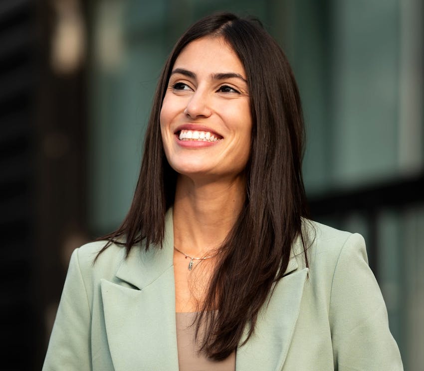 woman smiling in green suit jacket