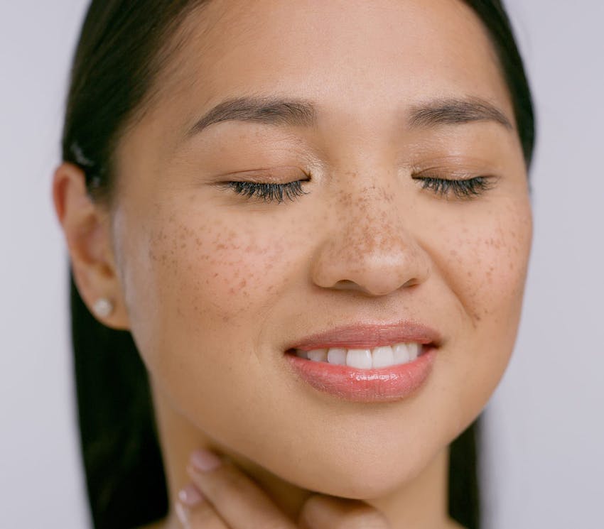 close up on woman's face with her eyes closed
