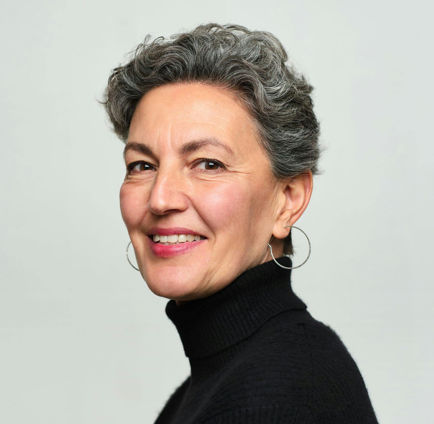 woman wearing a black turtle neck with short gray hair