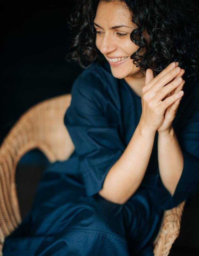 Woman sitting in a chair, smiling