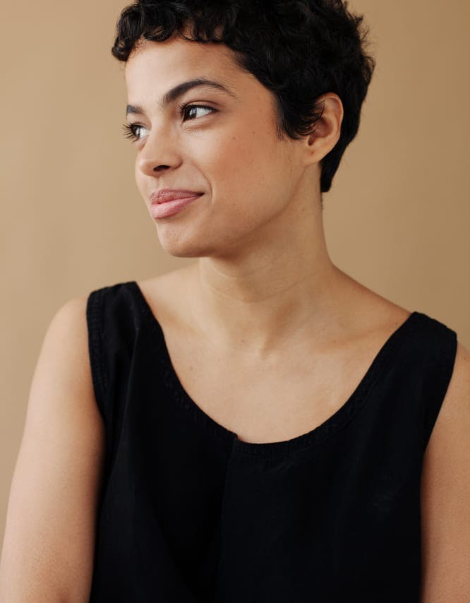 Woman In a black top, looking to the side