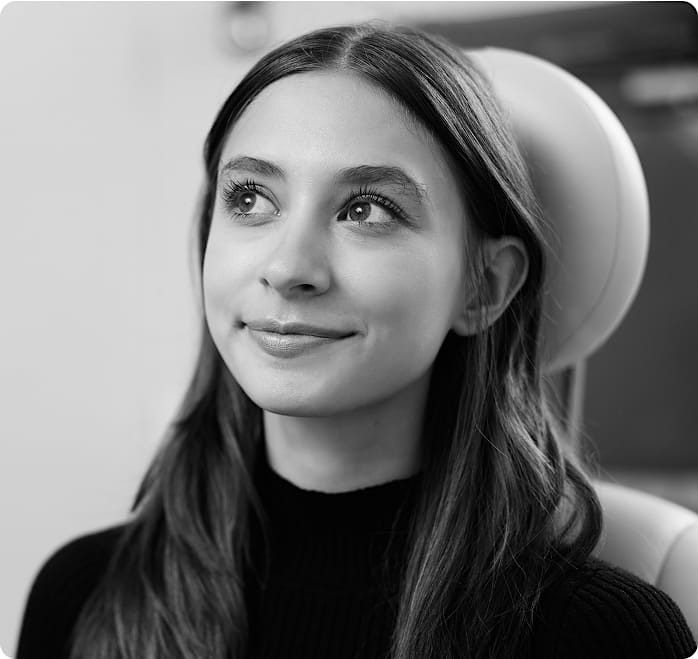 Black and white image of a girl in a patient chair