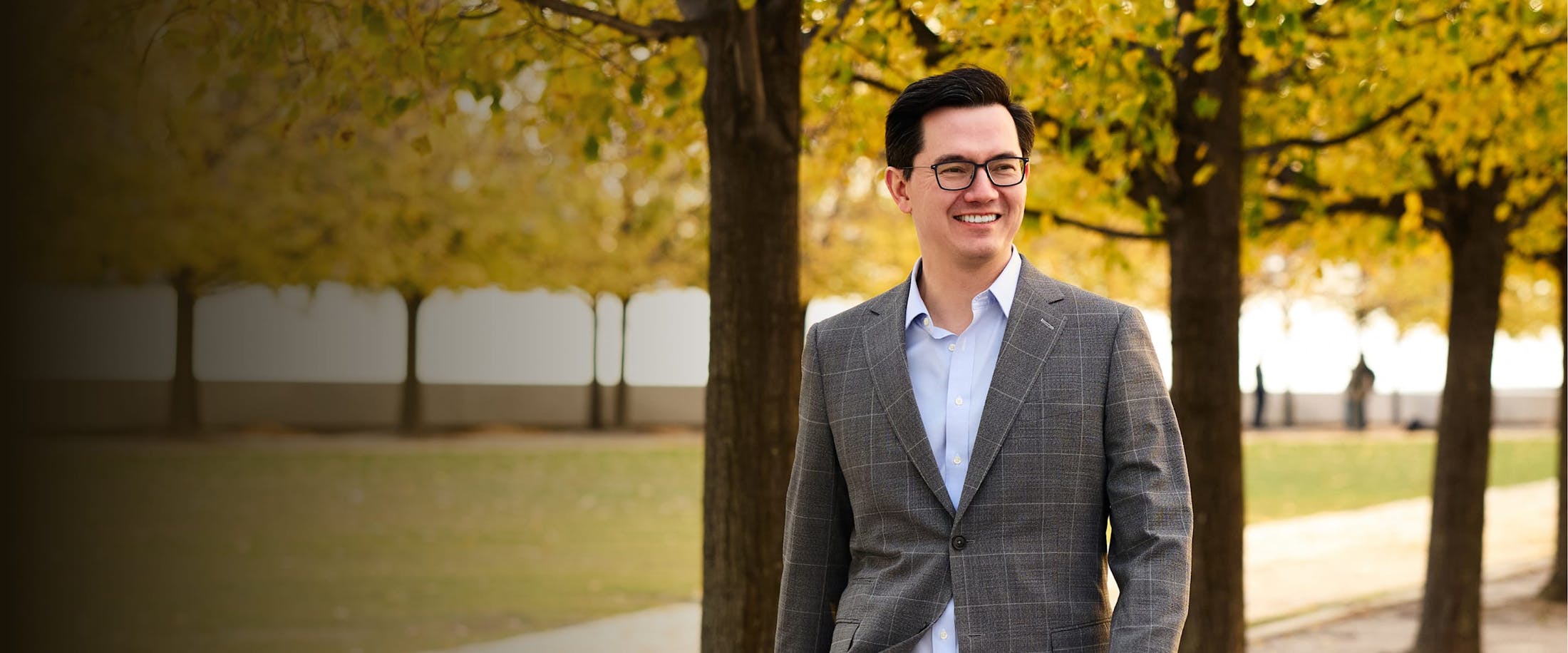 Dr. Leong in front of some trees
