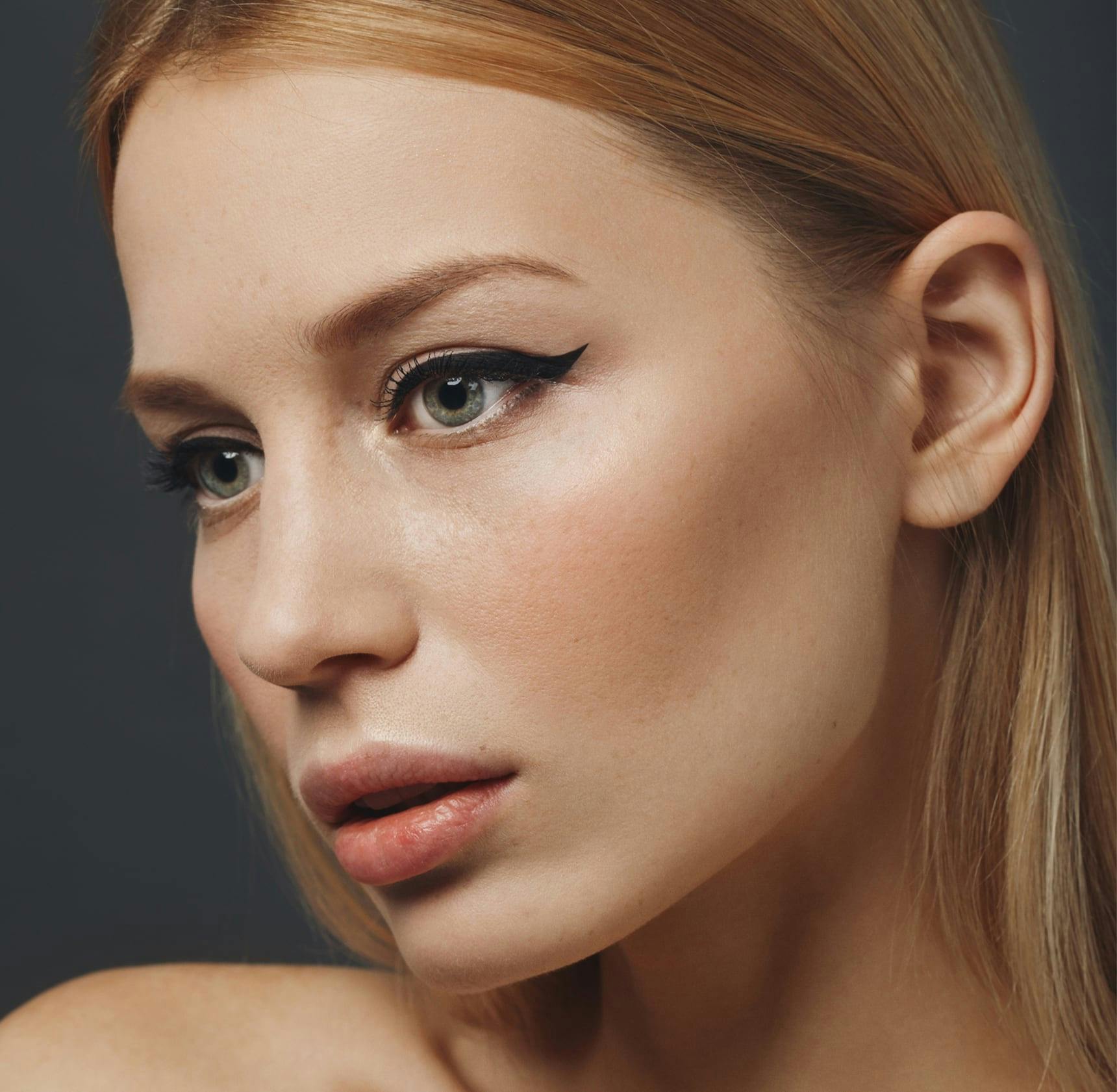 woman with makeup looking away from camera