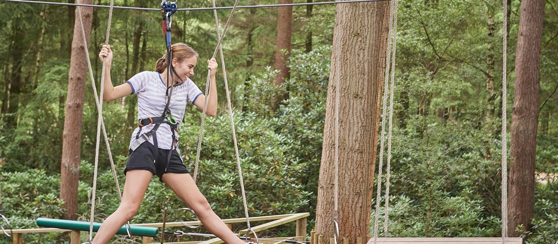 Person on a high ropes course.