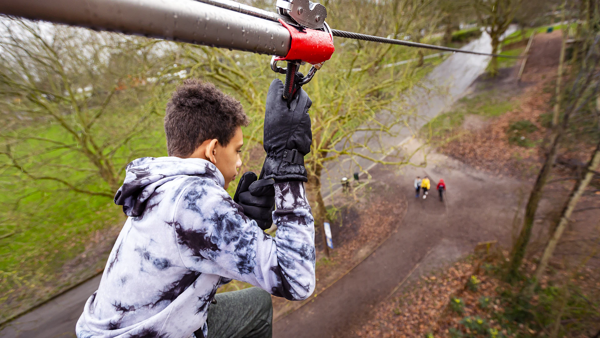 Young person steps from a zip wire.