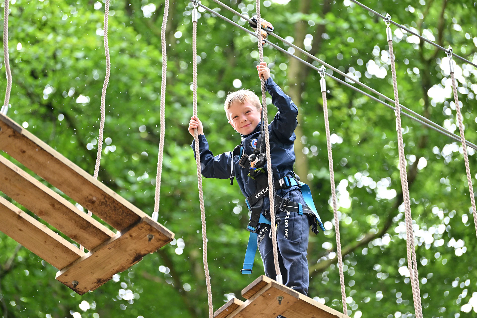 Young person on a high ropes course.
