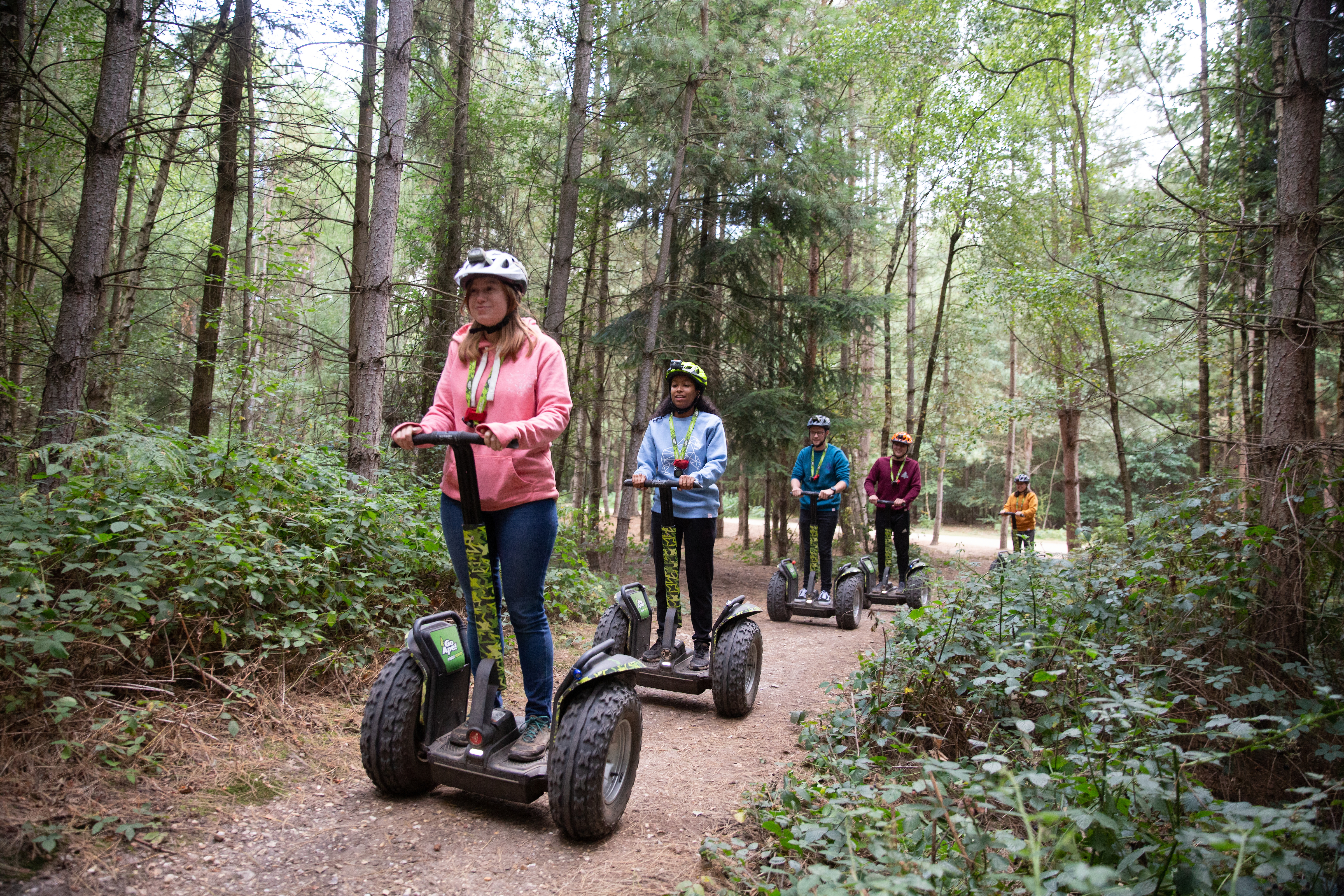 A group of people ride Forest Segways on a Go Ape adventure