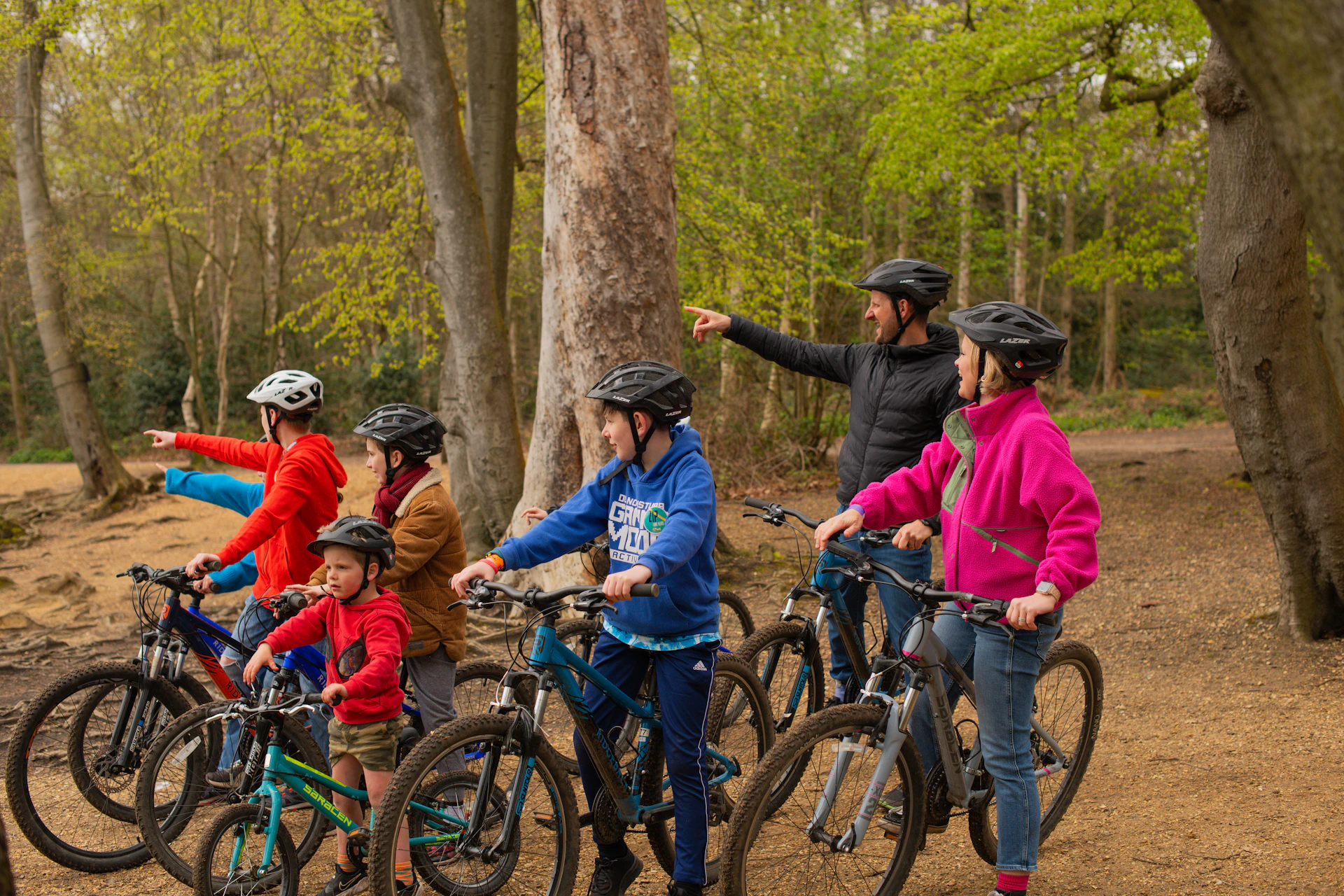 Family group on bikes in the forest.