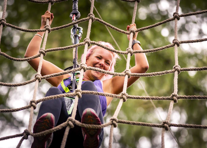 Person climbing a cargo net.